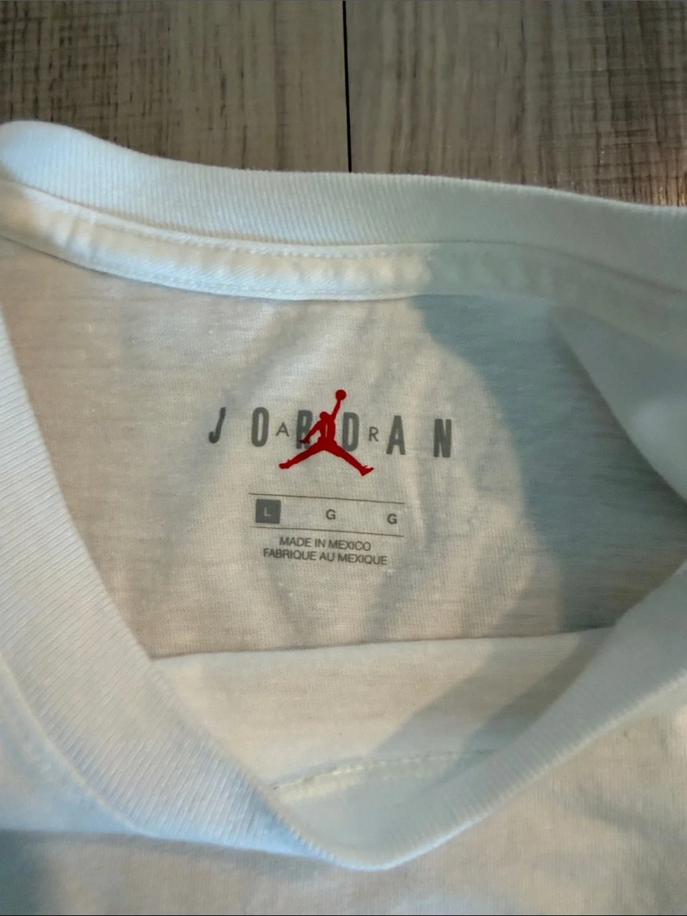 Jordan White Short Sleeve Tee with Black Graphic 'X' and Chest Stripes